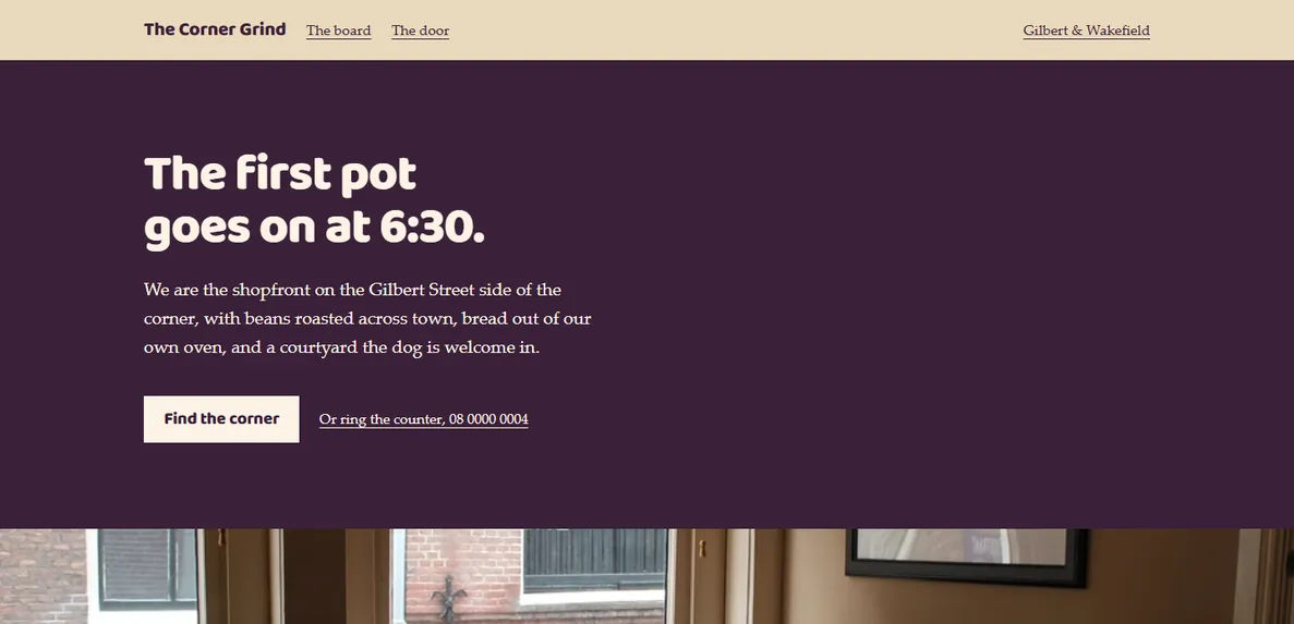 The Warm Local design, filled in for a sample café: a deep aubergine hero over a photograph of a café interior